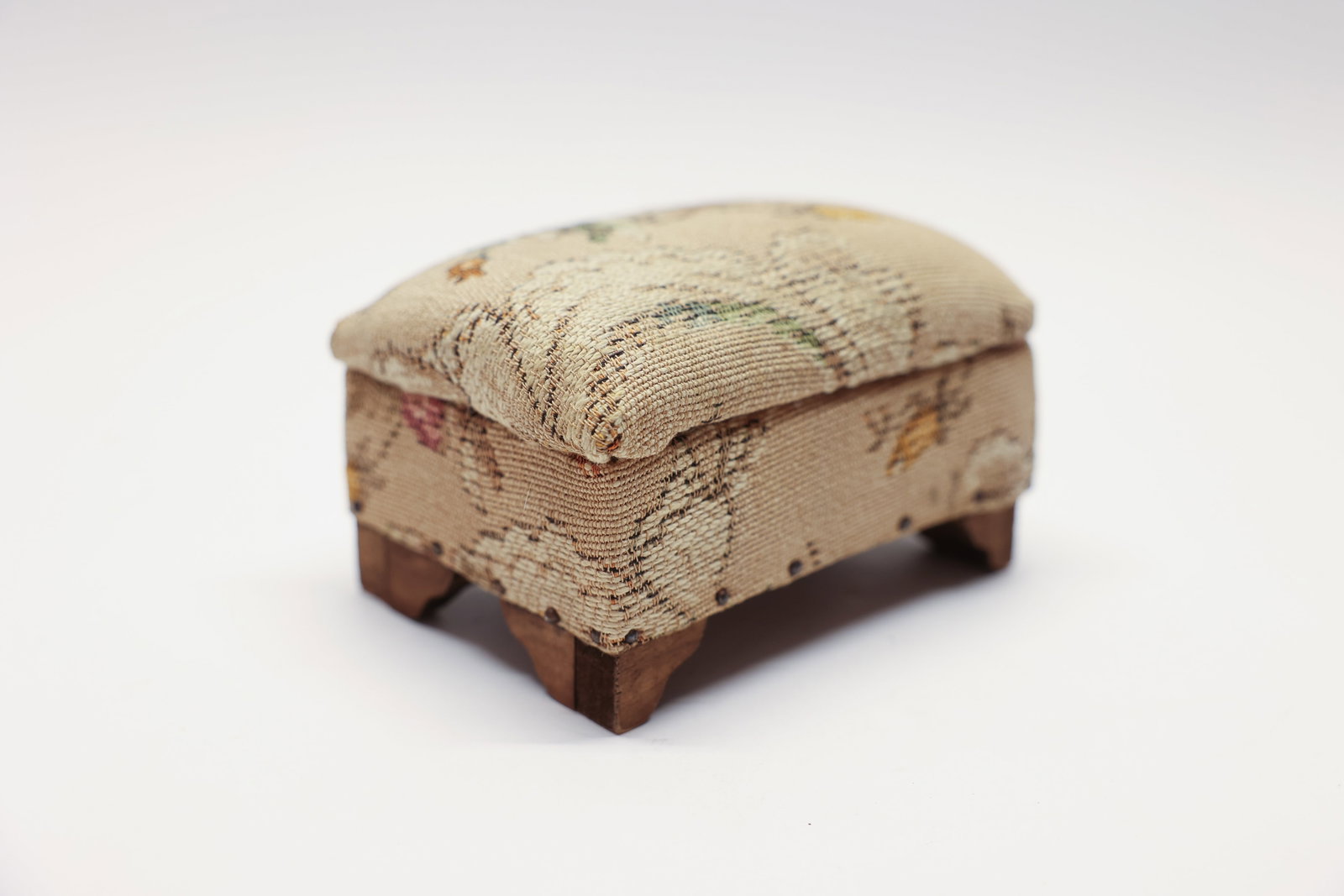 Dollhouse Miniature Foot Stool, Wood & Upholstery: Antique dollhouse furniture ottoman. Wood and upholstery. Very cute. 5 inches long 3 inches tall about 4 inches.Dimensions: H: 3", W: 4", L: 5"