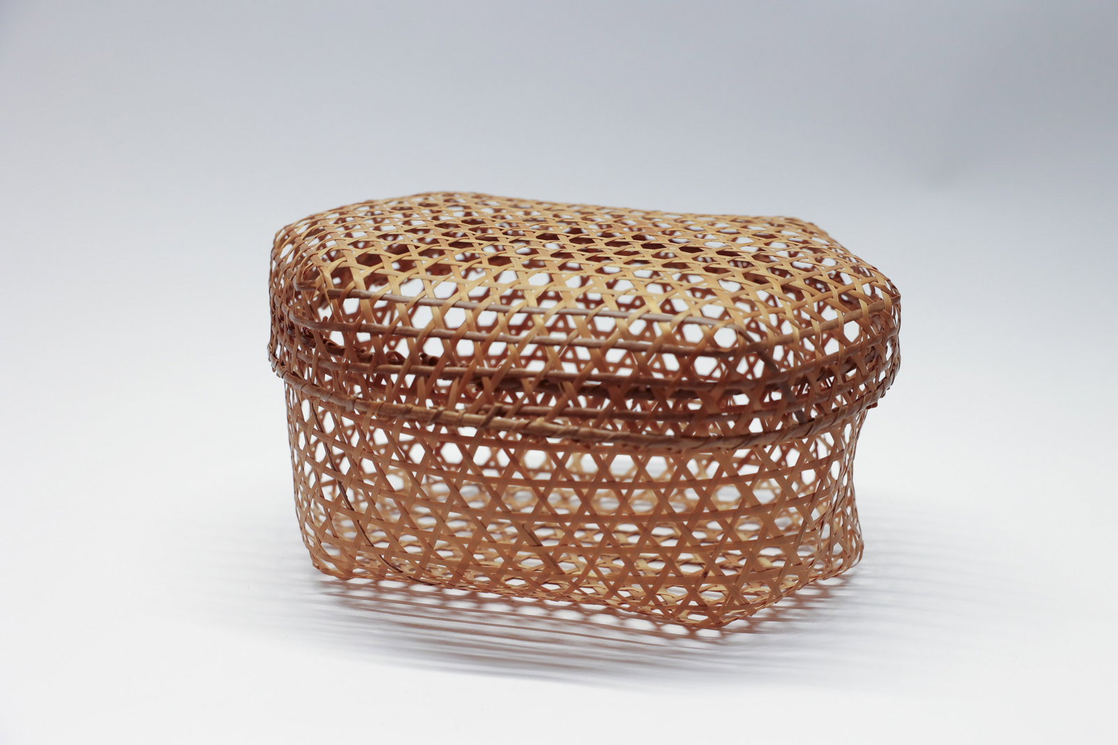 Rattan Woven Lidded Cheese Basket: Lidded. Rattan cane open weave. 11" long 9" wide 6" tall.Dimensions: H: 6", W: 9", L: 11"
