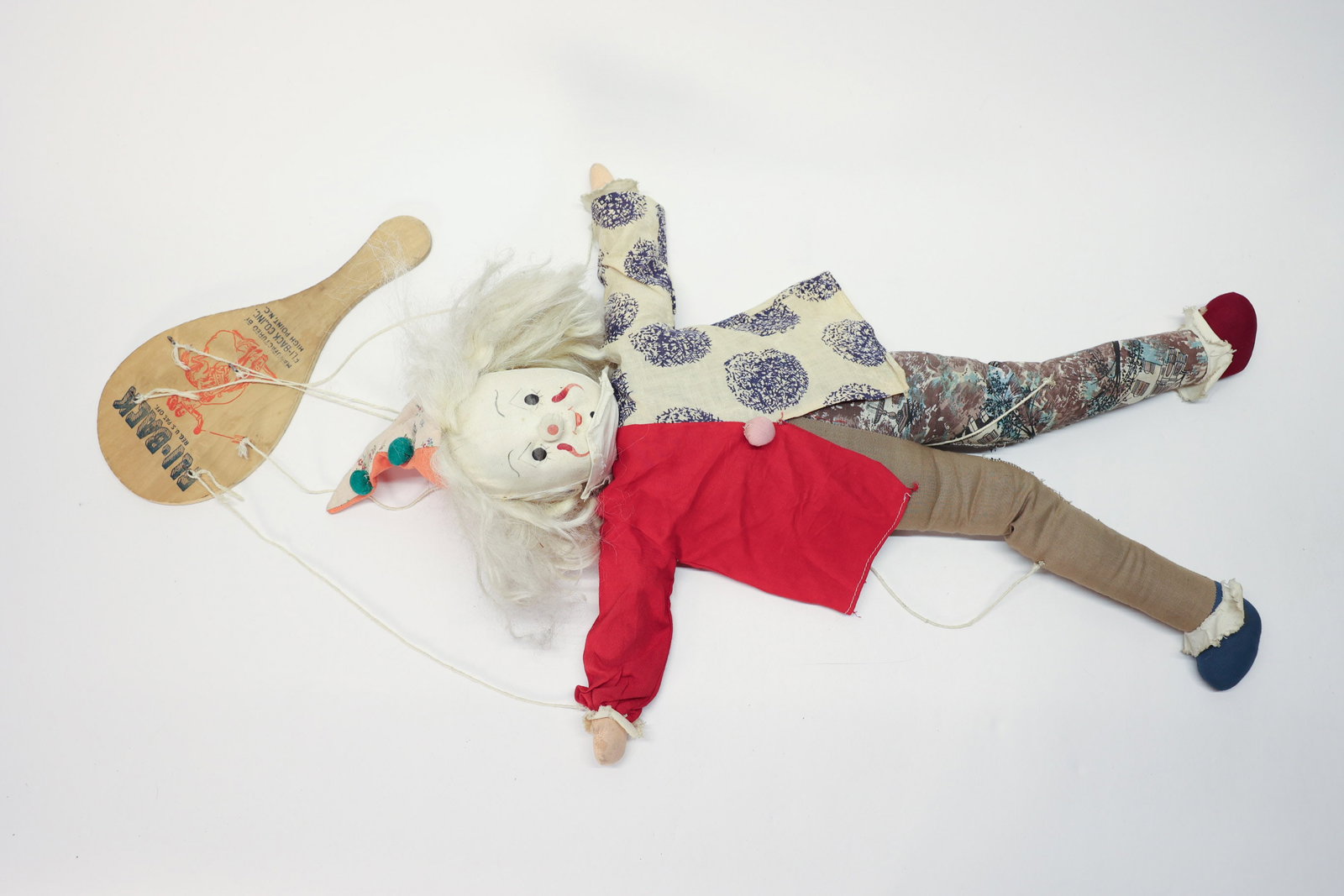 Homemade Clown Marionette Doll: Interesting piece. Hand painted face. Fly back paddle. 21" tall.Dimensions: H: 21", W: 3", L: 3"