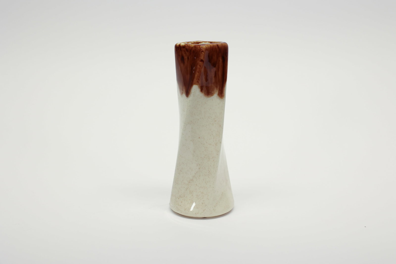 McCoy Floraline #542 Drip Glaze Vase: Vintage ceramic vase from McCoy Pottery's Floraline line, marked "542 Floraline USA" on the base. Features a tall, gently twisted hourglass silhouette in a soft speckled cream/oatmeal glaze, topped