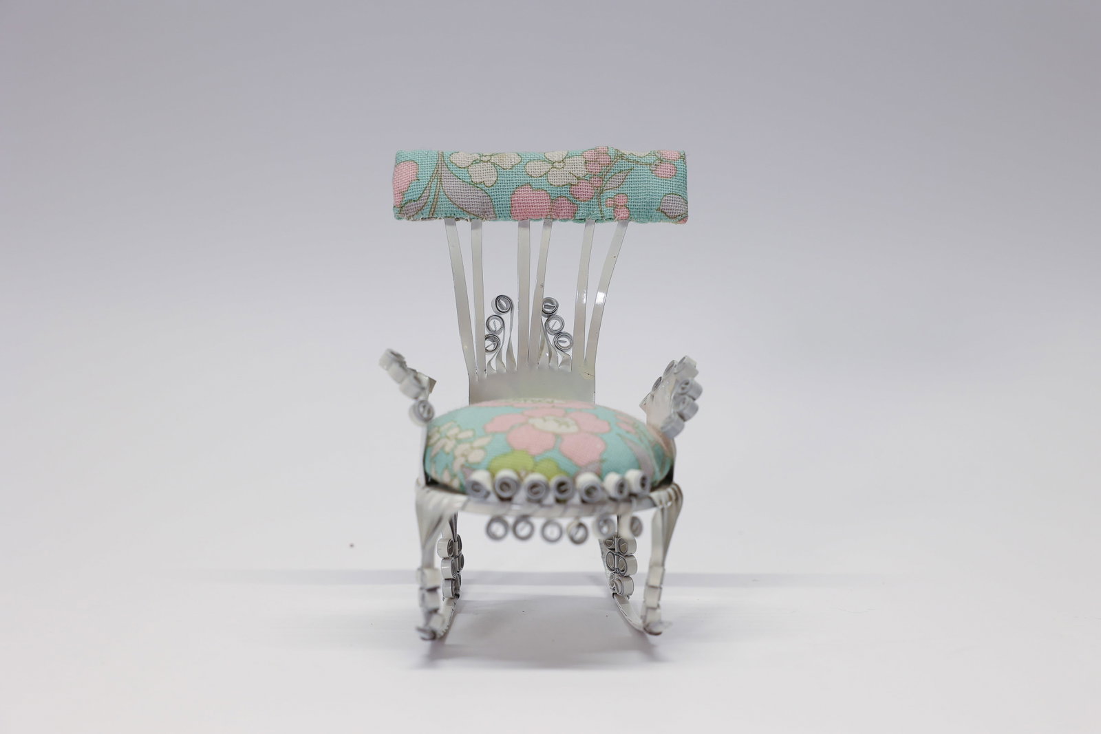 Lee Wideau Dollhouse Rocking Chair / Pincushion: Sweet little metal and fabric dollhouse rocking chair or pin cushion. It was made by a Lee Wideau of Homedale, Idaho.Dimensions: H: 5", W: 3.5", L: 3"