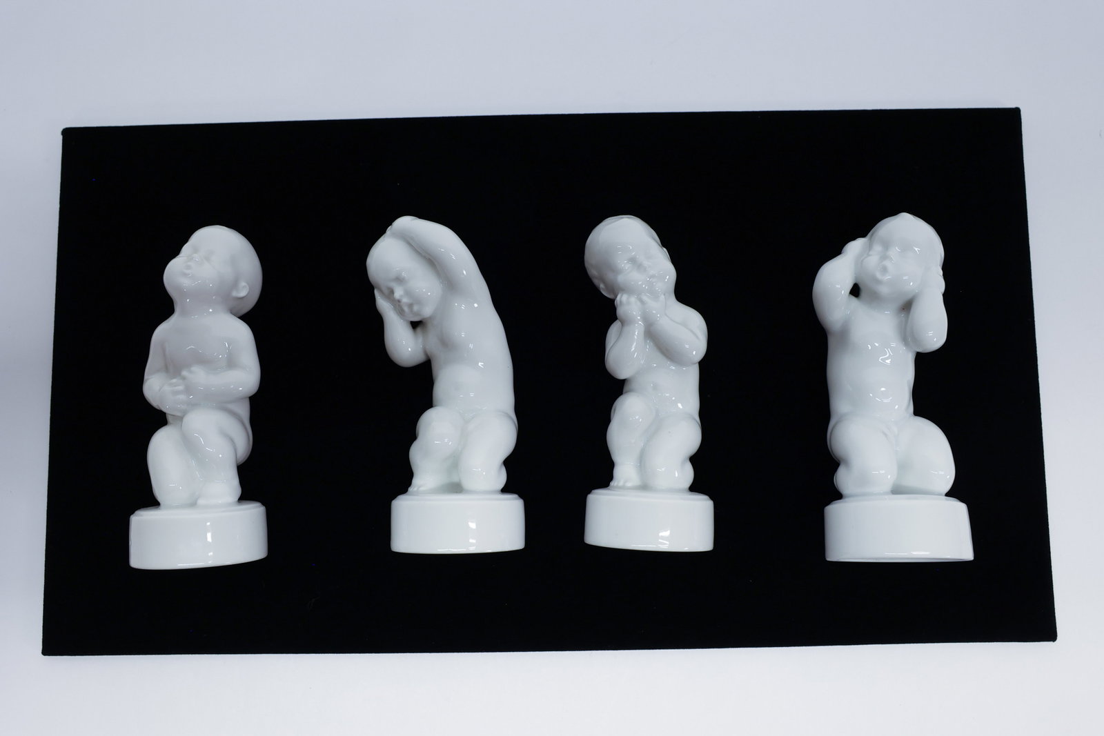 B&G 'The Four Aches' Danish Porcelain Figurines: Description:A complete set of four white porcelain baby figurines from "The Four Aches" (Danish: "de 4 Piner") series by Bing & Grøndahl of Denmark, modeled by Svend Lindhart, marked "Made in