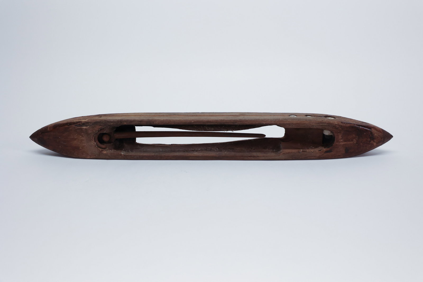 Antique Carved Wood Weaver's Boat Shuttle: Description:An antique wooden boat shuttle used for weaving on a hand or floor loom, carved from a single piece of hardwood with graceful pointed, tapered ends that allowed it to glide smoothly