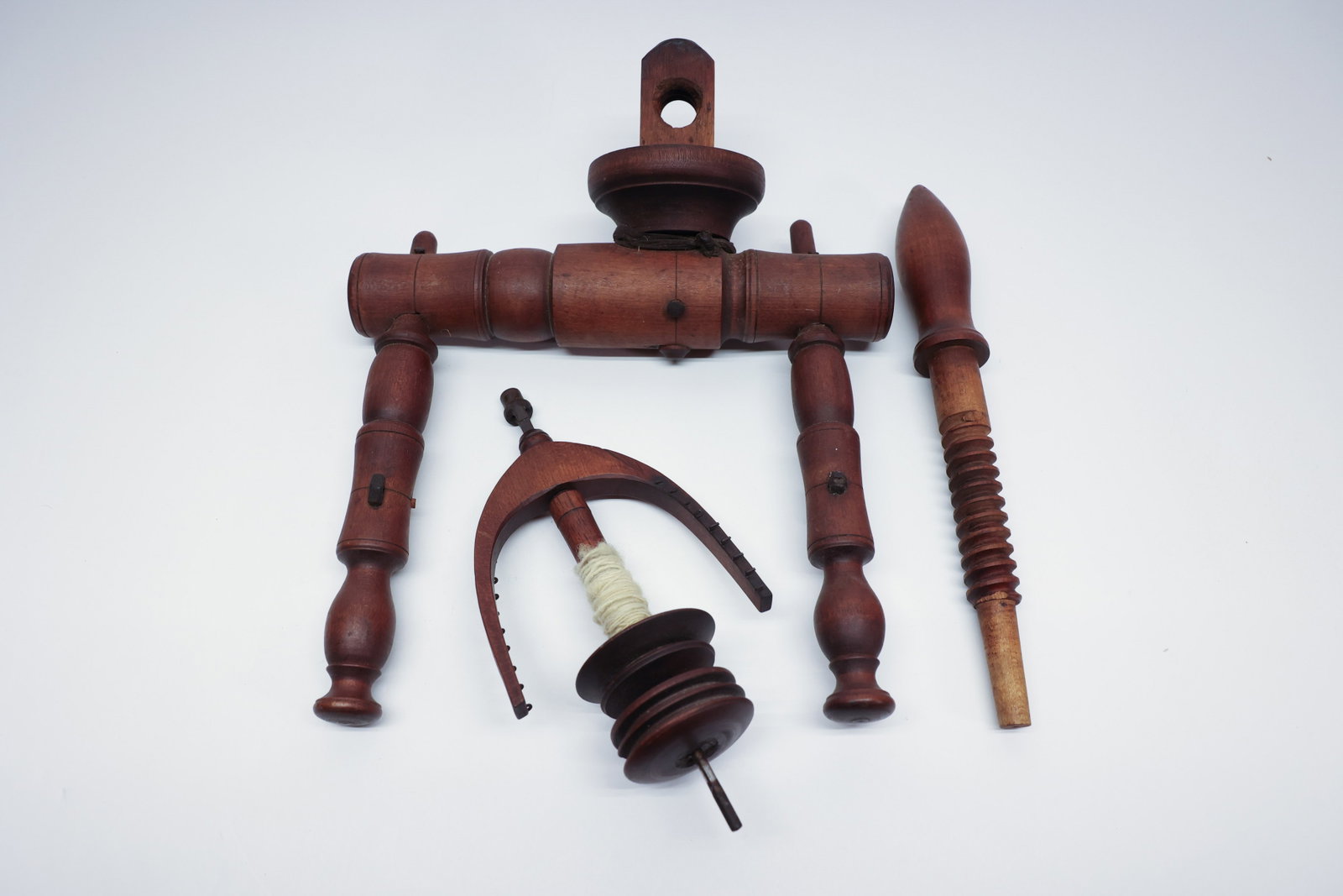 Antique Spinning Wheel Flyer & Bobbin Parts: Description:A lot of antique turned wood spinning wheel components: a mother-of-all with maidens, a flyer with its wound bobbin still on the spindle, and an additional turned wood accessory piece. No 