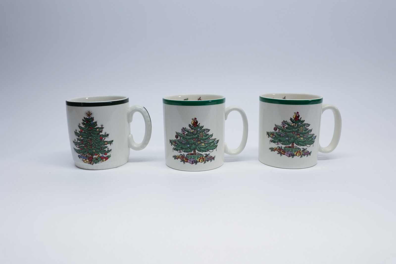 Spode & Cuthbertson Christmas Tree Mugs, Set 3: Description:A set of three English earthenware Christmas tree mugs from two different makers: two are marked "Spode, Made in England, Christmas Tree, S3324-A0" and feature Spode's well-known
