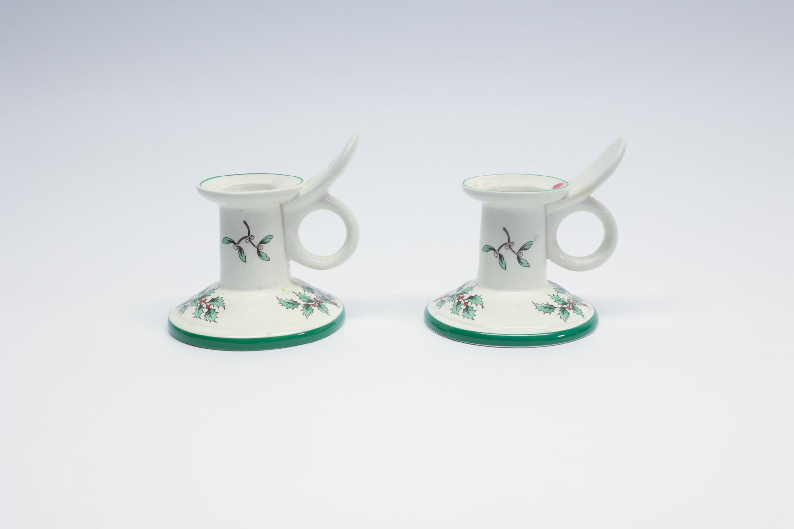 Spode Christmas Tree Chamberstick Candle Holders: Description:A pair of Spode "Christmas Tree" pattern chamberstick-style candle holders, English earthenware marked "Spode, England, S3324-F, Christmas Tree" on the underside. Each holder has a finger 