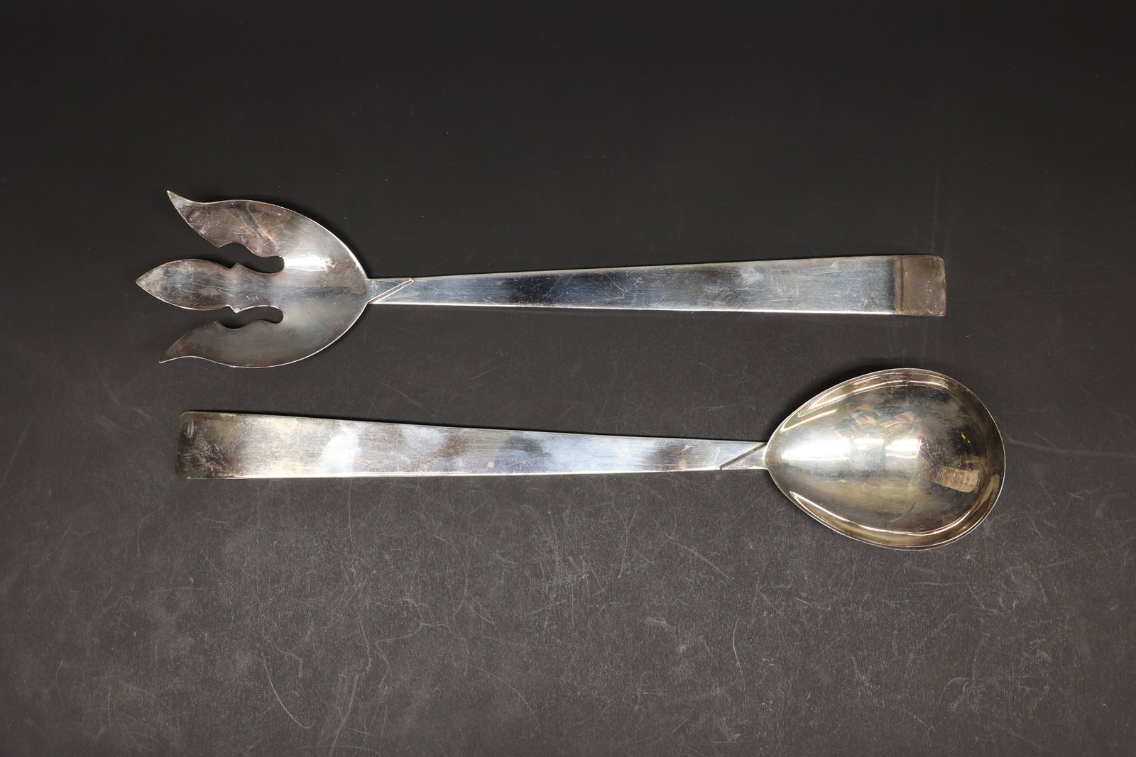 Silver-Plate Salad Server Set, Fork & Spoon: Two small spoons carved from mother-of-pearl, each with an iridescent rounded bowl and slender tapered handle. Traditionally used for salt cellars, as the shell material won't react with salt the way 