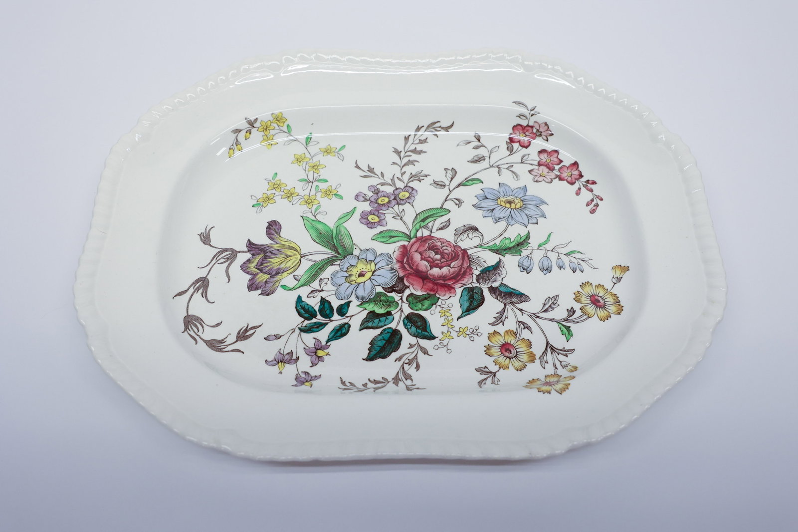 Copeland Spode "Romney" Gadroon Platter: Oval platter in the Copeland Spode "Romney" pattern, Gadroon shape, England. Multicolor transferware floral design with a central rose, blue daisy, and yellow tulip bouquet, with sprays of purple, pin