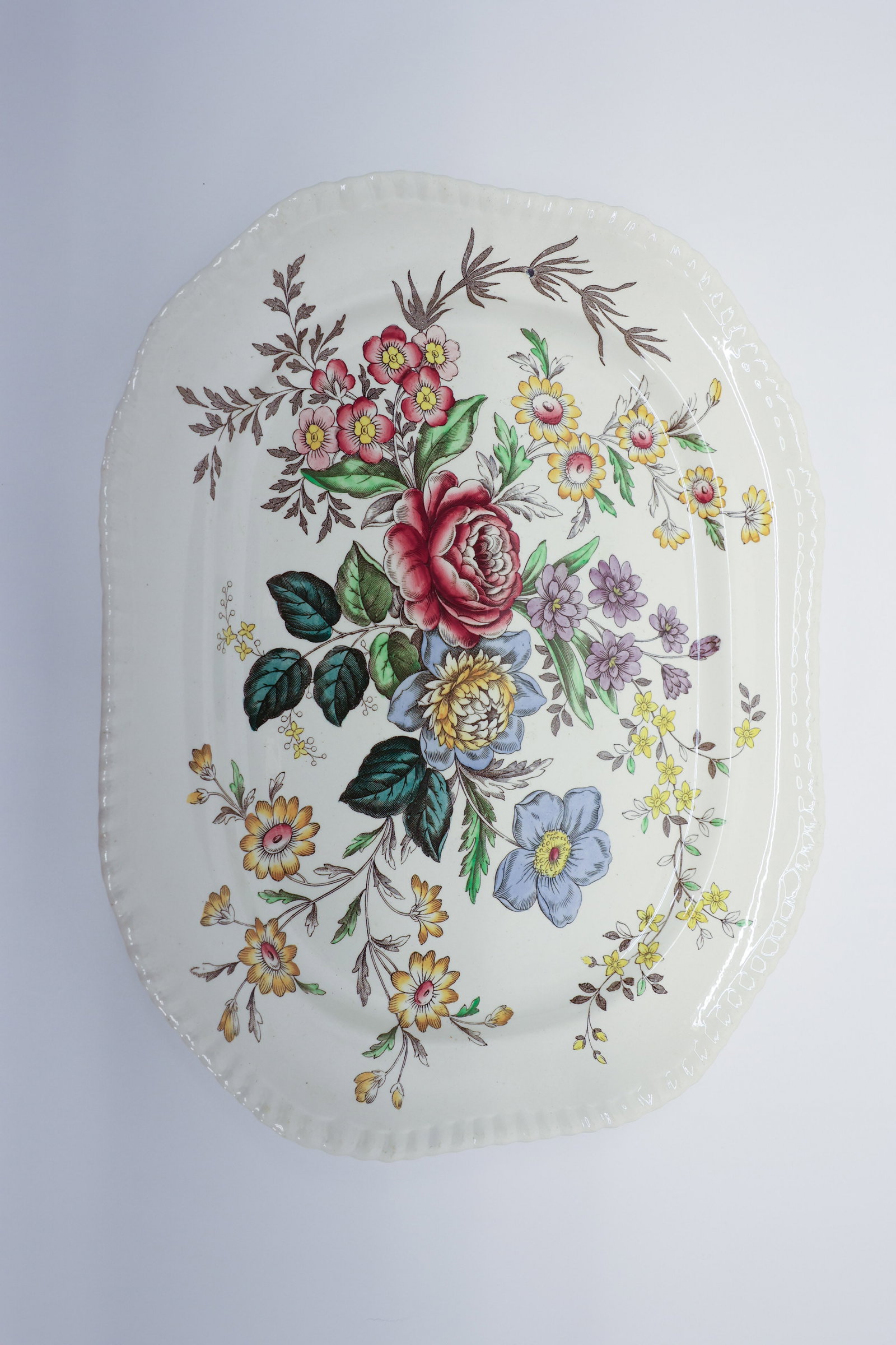Copeland Spode "Romney" Gadroon Oval Platter: Oval platter in the Copeland Spode "Romney" pattern, Gadroon shape, England. Multicolor transferware floral design with a central rose, blue peony, and mixed blossom bouquet, with sprays of daisies, p