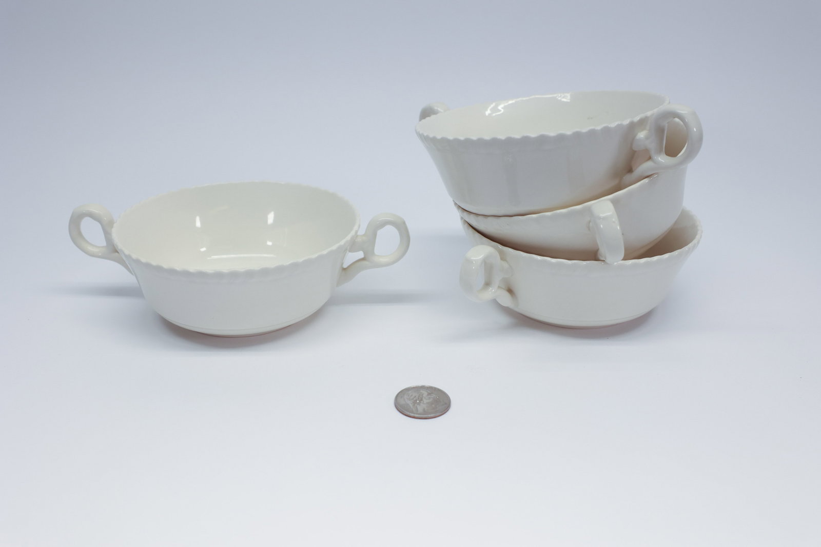 Spode "Gadroon" Cream Soup Bowls, Set of 4 Blank: Set of four white earthenware two-handled bouillon/cream soup bowls in Spode's "Gadroon" design (c. 1823), gadrooned rim with loop handles. Base marked "Spode, England, Gadroon, Spode Design, c.1823."