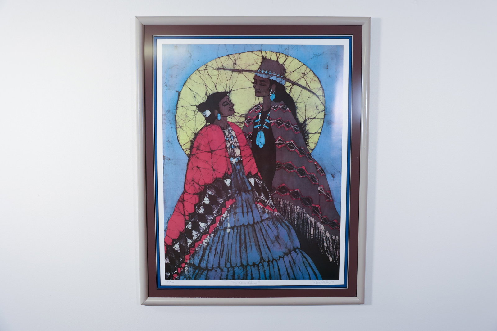 Alice Valdez "La Luna Llena" Signed Batik Print: Limited edition print (149/500) of a batik-style artwork depicting two women in traditional dress with turquoise jewelry, standing before a full moon and bare tree branches, in a palette of blue, pink