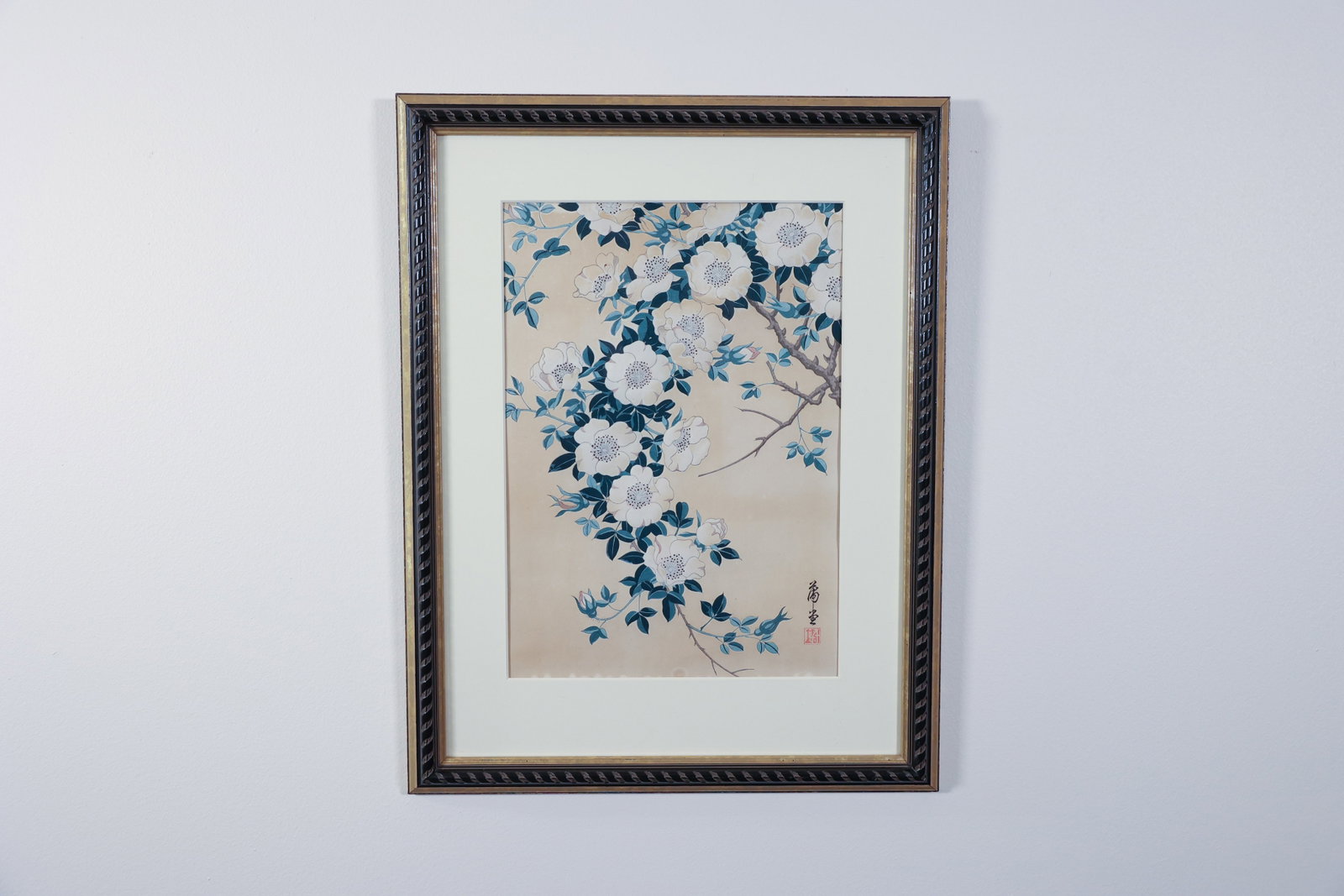 Japanese Woodblock Print, White Wild Roses, Signed: Woodblock print depicting a branch of white wild roses (nobara) with blue-green leaves against a tan ground, a small bird partially visible among the foliage. Signed in brush lower right with a red ar