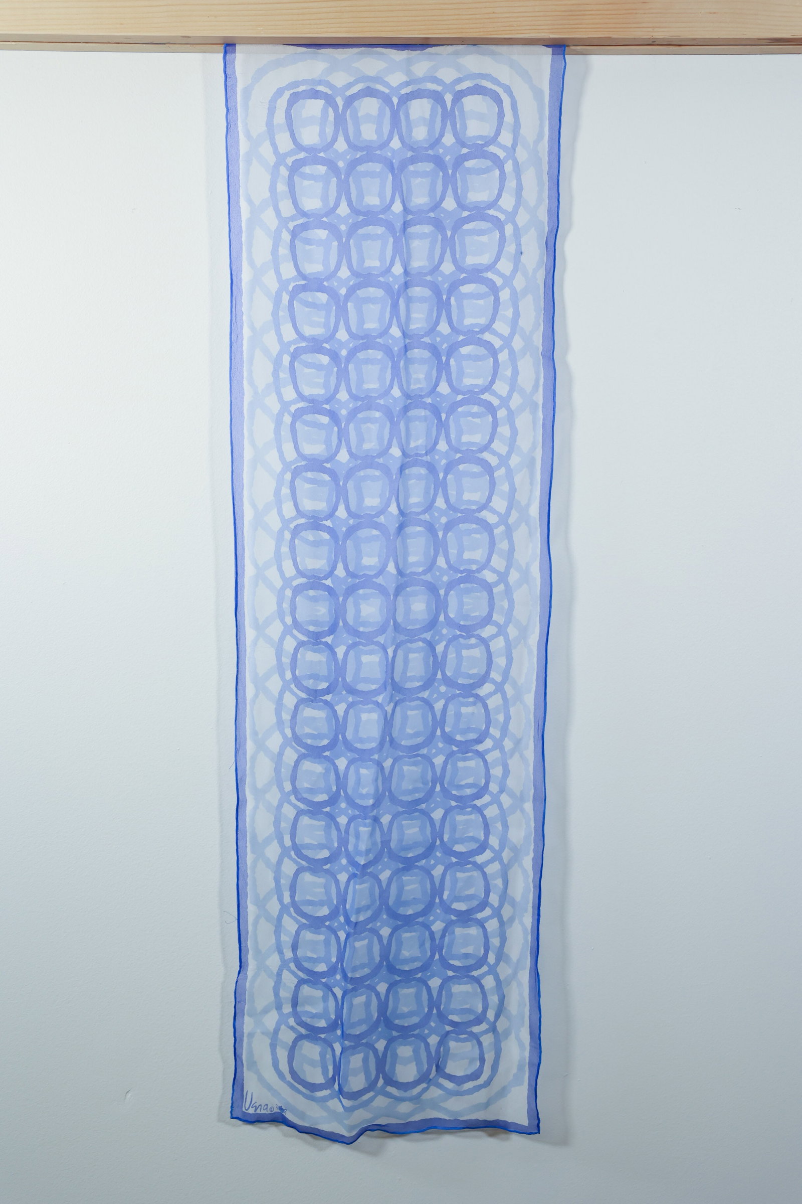 Vera Neumann Silk Scarf, Blue Ring & Lattice Print: Sheer silk scarf with an allover print of interlocking rings in shades of blue over a diamond lattice ground. Solid blue border along the edges. Hand-rolled hem. Signed "Vera" with copyright mark and 