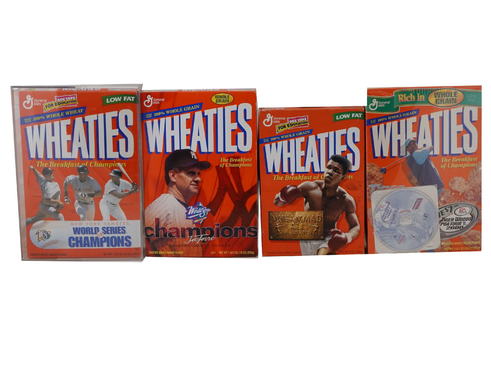 4 WHEATIES BOXES FEATURING SEALED BOXES: This lot includes four unique Wheaties boxes, each representing a piece of sports history. One box is encased in plastic, showcasing the 1998 World Series-winning Yankees and carefully preserved for