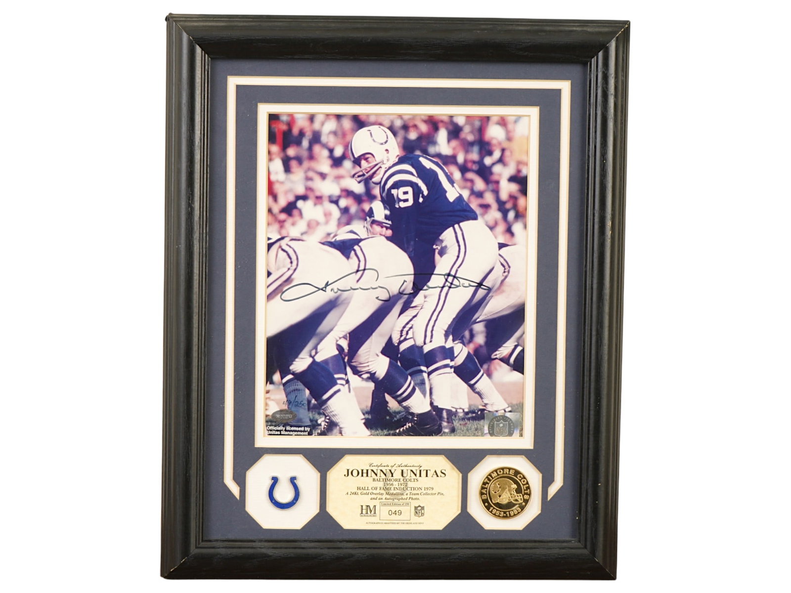 JOHNNY UNITAS COLTS SIGNED COMMEMORATIVE DISPLAY: A limited edition (49/250) Highland Mint commemorative display honoring Johnny Unitas. Includes an autographed photo, a gold-plated medallion, and a Baltimore Colts team collector pin. Baltimore Colts