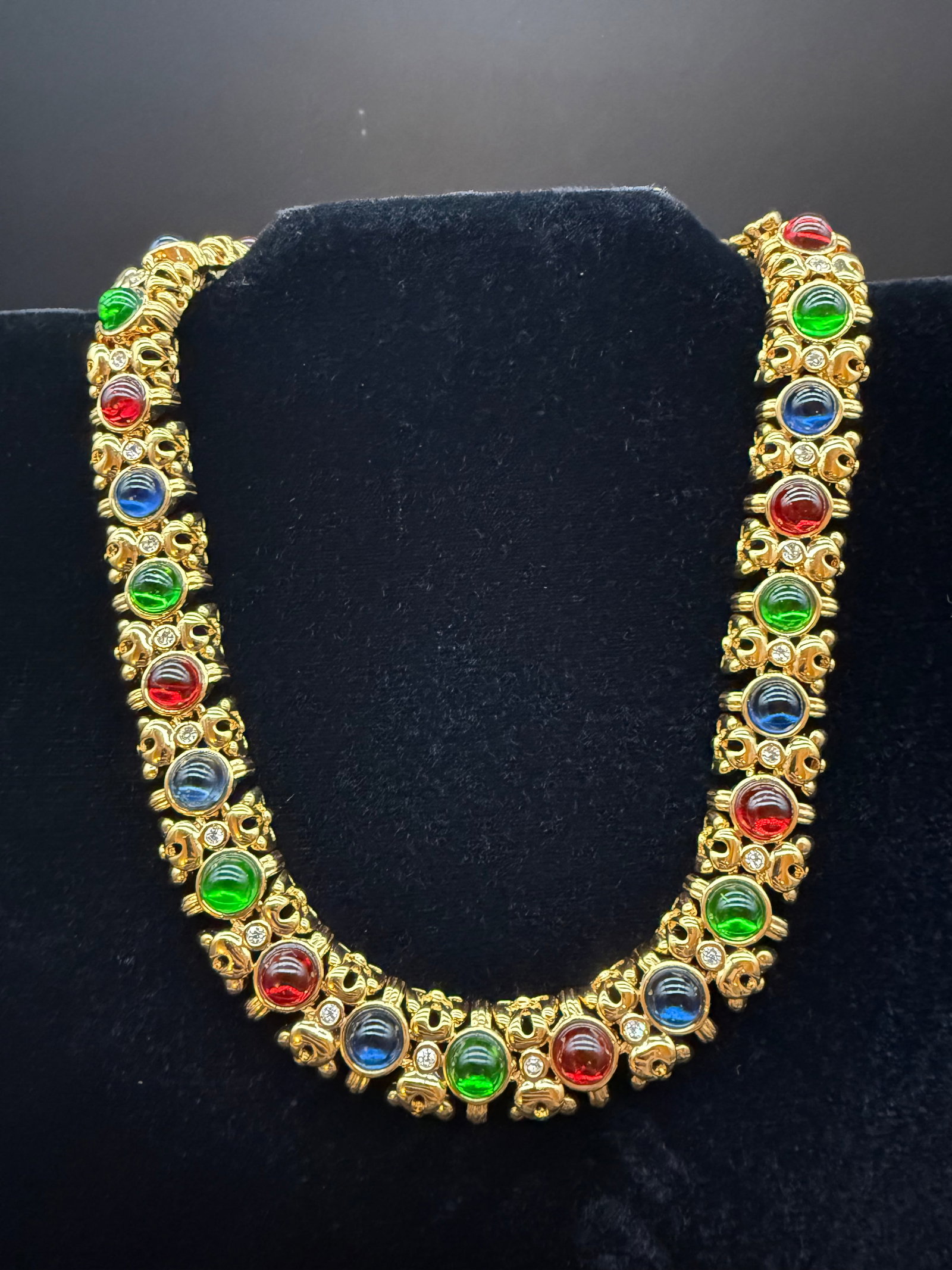 Nina Ricci gold tone necklace: Nina Ricci signed necklace. Necklace includes green, blue, and red glass stones. necklace also includes 2 signed clasps.