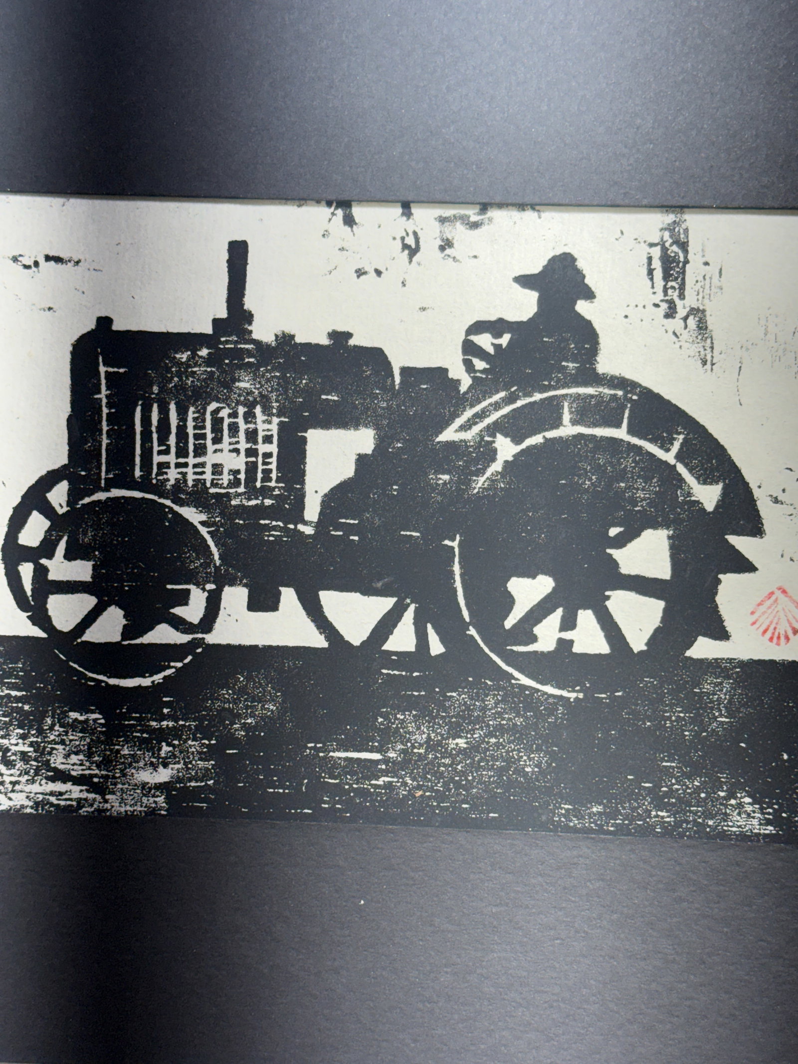 Steam Tractor Woodcut Art Traction Engine Farm Machinery Industrial Operator Framed: Hand-pulled black-and-white woodcut or stencil artwork depicting an early steam traction engine and its seated operator. The agricultural machine is shown in profile, emphasizing its monumental spoked