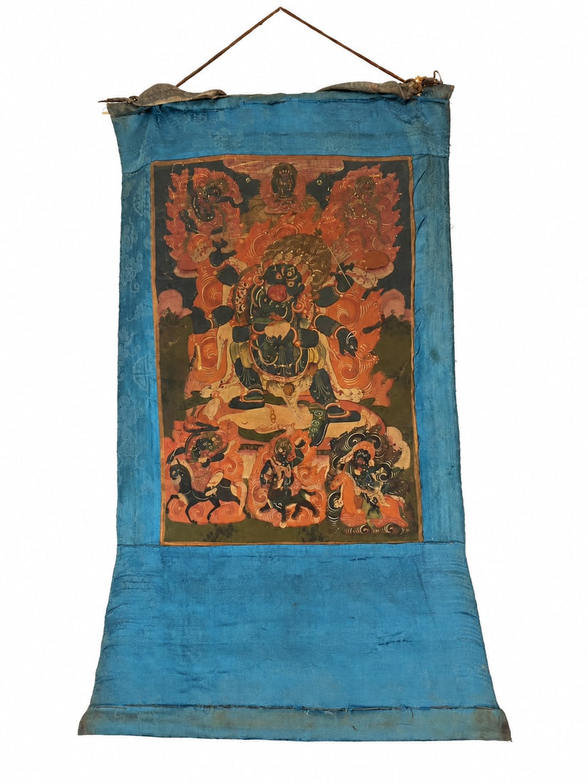 Qing Dynasty Mongolian-Style Thangka of Six-Armed Mahakala and Retinue: A Mongolian-style thangka depicting six-armed Mahakala, shown with a dark blue body, three eyes, a skull crown, and a fierce expression, surrounded by swirling orange-red flames. His principal hands h