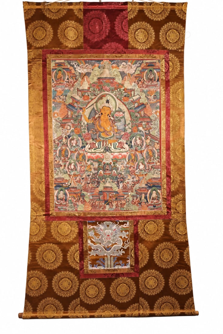 Ming Dynasty Hand-painted Thangka of Ming Dynasty Hand-painted Thangka of: A large thangka depicting Manjushri seated on a lotus throne, raising a flaming sword in his right hand and holding a lotus stem supporting a scripture at his left shoulder. The central figure is surr