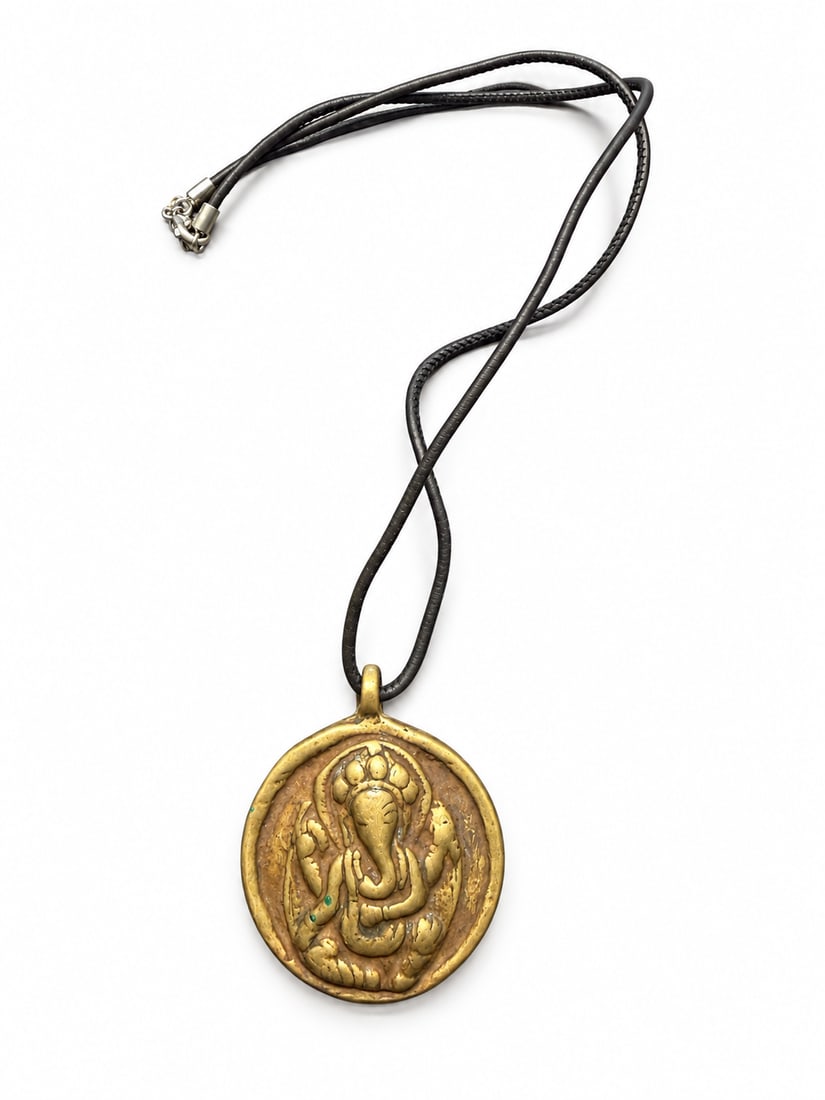 Rare Qing Dynasty Tibetan Ganapati and Nine-Palace Bagua Amulet: A Tibetan Ganapati, or elephant-headed wealth deity, amulet,Qing dynasty. The rounded pendant features a seated elephant-headed deity in relief on one side and a Nine-Palace Bagua design with surround