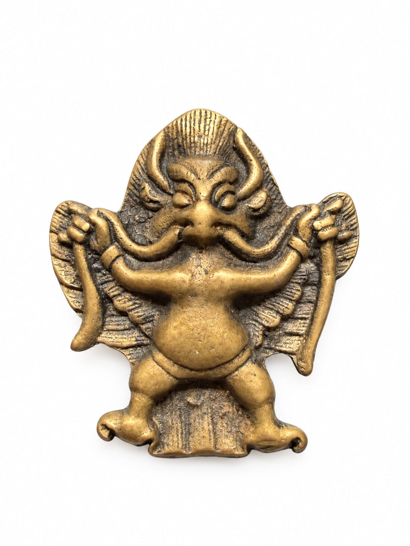 Qing Dynasty, Tibetan Garuda Thokcha Protective Amulet, Uncommon Form: A Tibetan personal protective amulet depicting Garuda, Qing-dynasty thokcha. Garuda appears frontally with outspread wings, prominent eyes, a powerful beak, and outward-turned feet, holding a serpent-