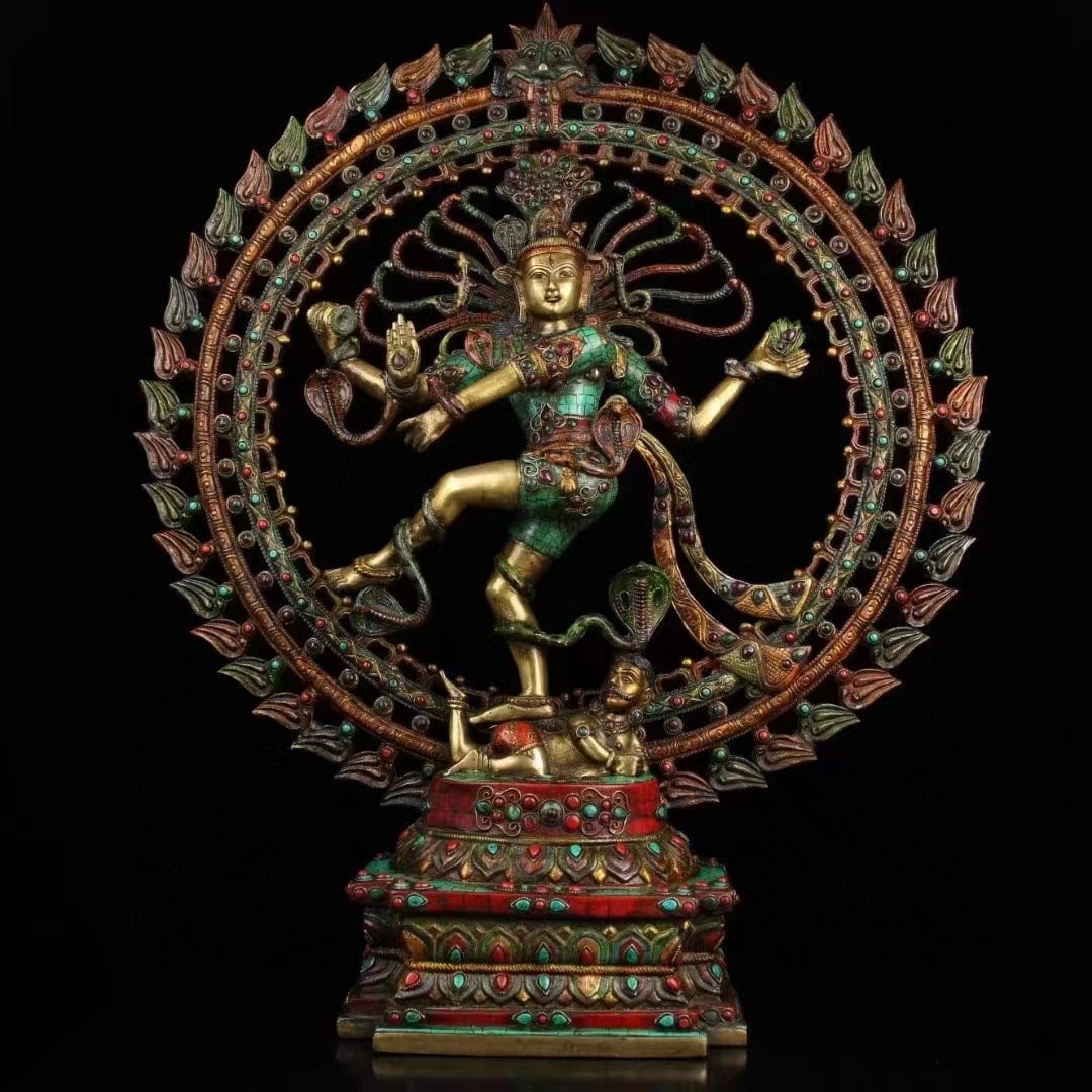 Large Nepalese Inlaid Figure of Shiva Nataraja with Flaming Aureole: A large Nepalese figure of Shiva as Nataraja, Lord of the Dance, framed by an elaborate circular aureole edged with flames. The four-armed deity stands in a dynamic dancing posture above a recumbent f