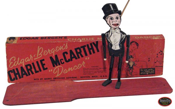 1938 Marx Bros. "Edgar Bergen's Charlie McCarthy Da: Edgar Bergen's Charlie McCarthy Dancer, 1938, Marx Bros. Co., box is 20 x 5", die-cut painted wood figure is 11", w/ dancing platform; Charlie is C9 in C5 box (missing end flaps).