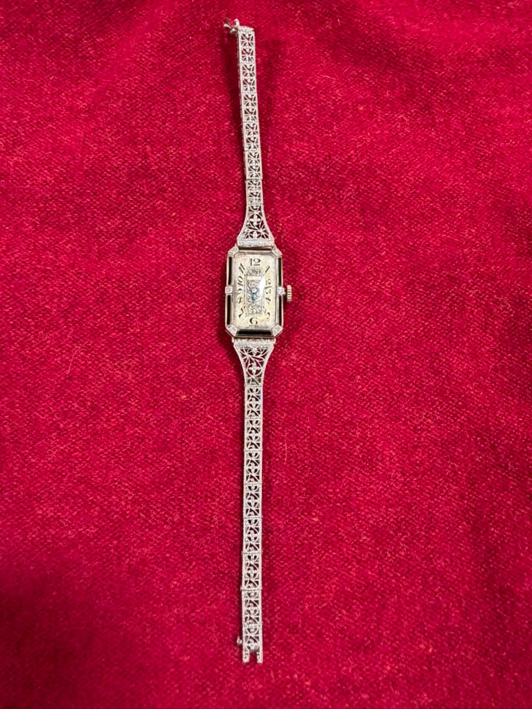 18 karat gold ladies watch: 18 karat gold ladies watch by Paul Vallette 15 jewels with 6 small diamonds and a 14 karat gold and platinum band. 10.6 DWT. Total weight with the works in it.