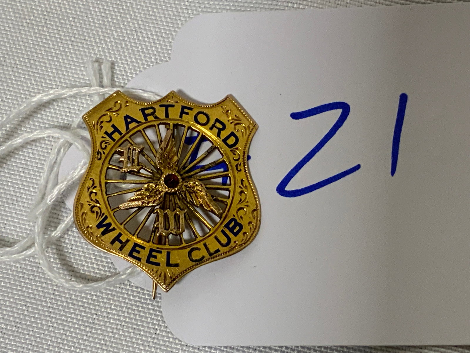 Hartford Wheel Club 10k Pin w/ Ruby: Hartford Wheel Club 10k pin with ruby. The Hartford Wheel Club in the 1890s was for wealthy people with high-wheel bicycles/penny-farthings. One additional letter (the C) is missing from the