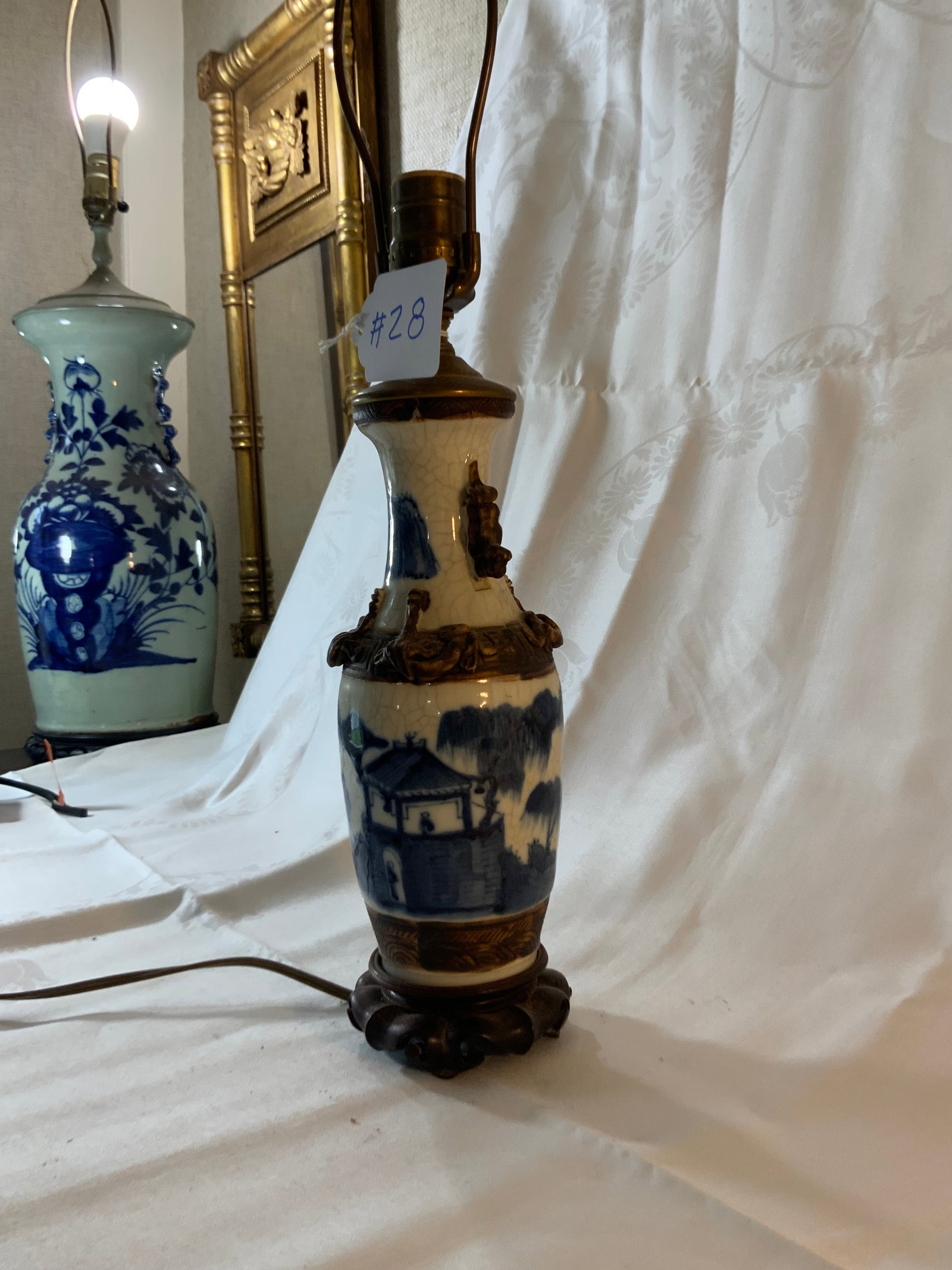 Oriental Lamp: Oriental lamp with blue decoration, applied handles and applied decorations, on a wooden base, 4 inches wide, 11 inches tall. Good condition.
