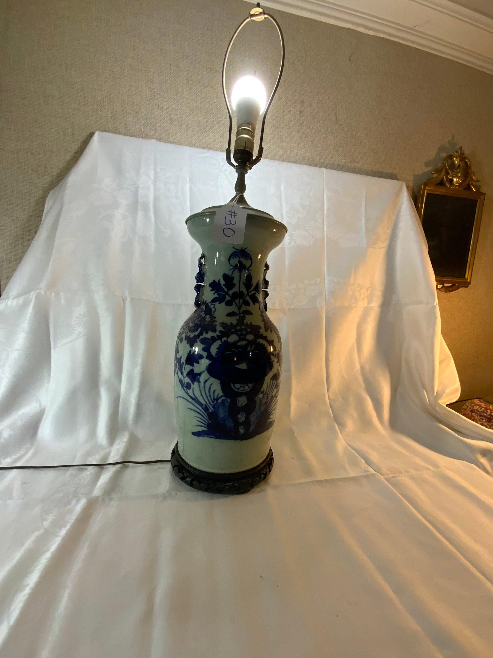 Oriental Lamp: Oriental lamp, blue and white decorations, applied handles, 7 inches wide, 18 inches tall, has a crack in the back, on a wooden base.