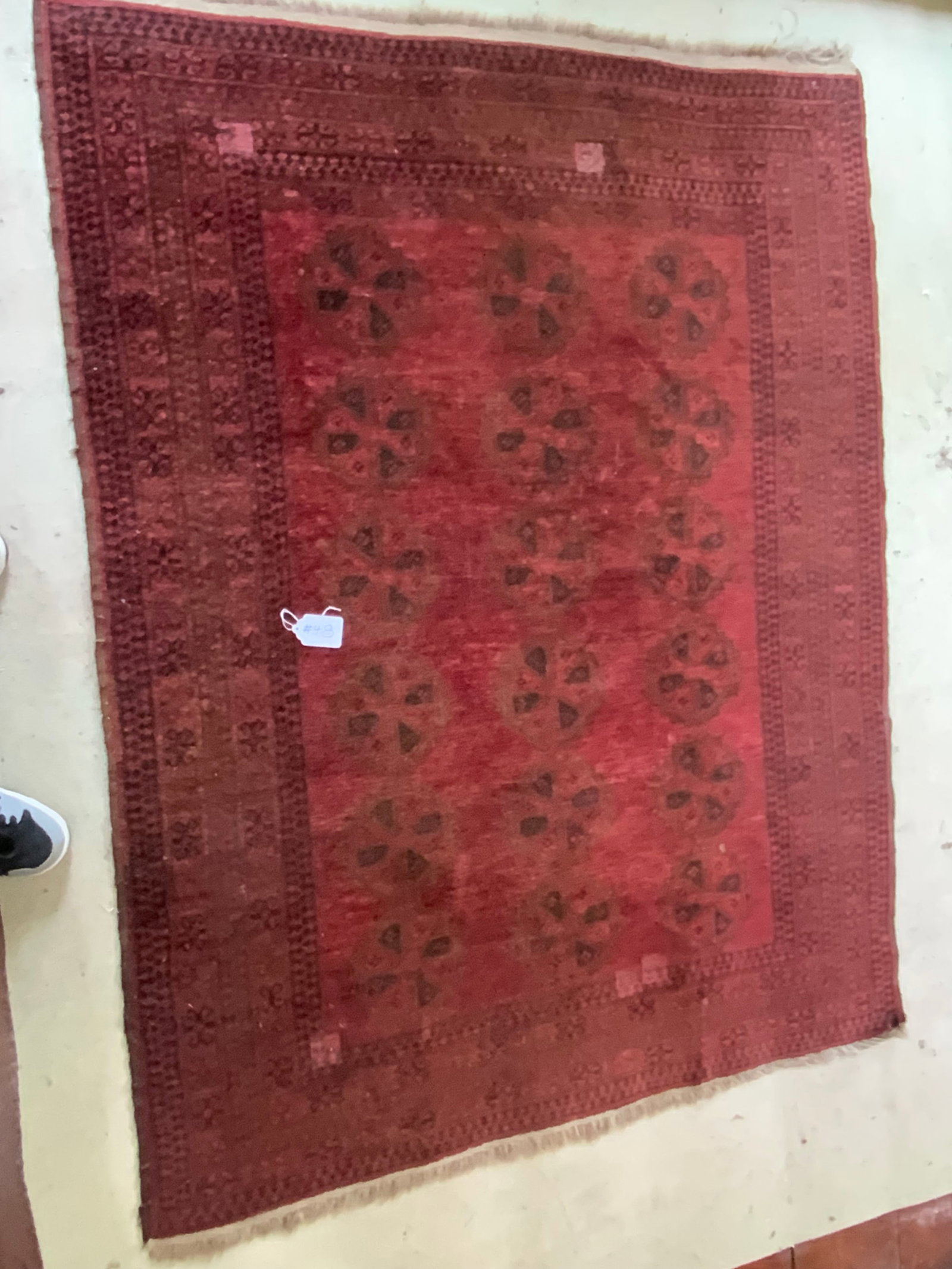 Oriental Tekke Carpet: Oriental Tekke floral rust carpet, red and rust geometric border. Good condition. Size to be added day of auction.