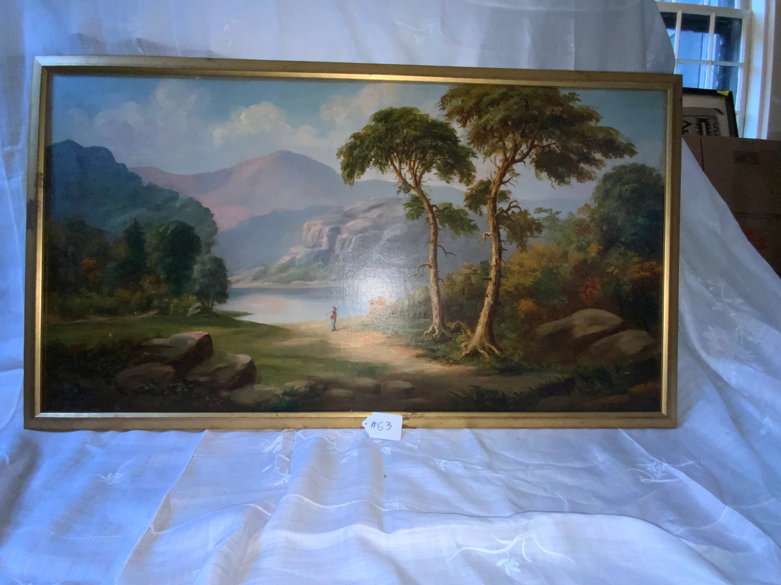 American School Painting: American School painting, 19th century, signed (illegible), a fisherman on lake w/ mountains, landscape, 24 1/2" x 45 1/2", gold frame, oil on canvas. Good condition.
