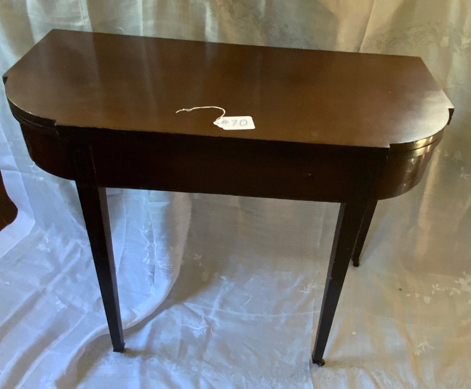 Card Table: Card table bench made by Joseph Rawson and Son, cabinetmaker, Providence, Rhode Island. Original label, swing leg, nice inlay, brass casters, original finish. Fair condition.