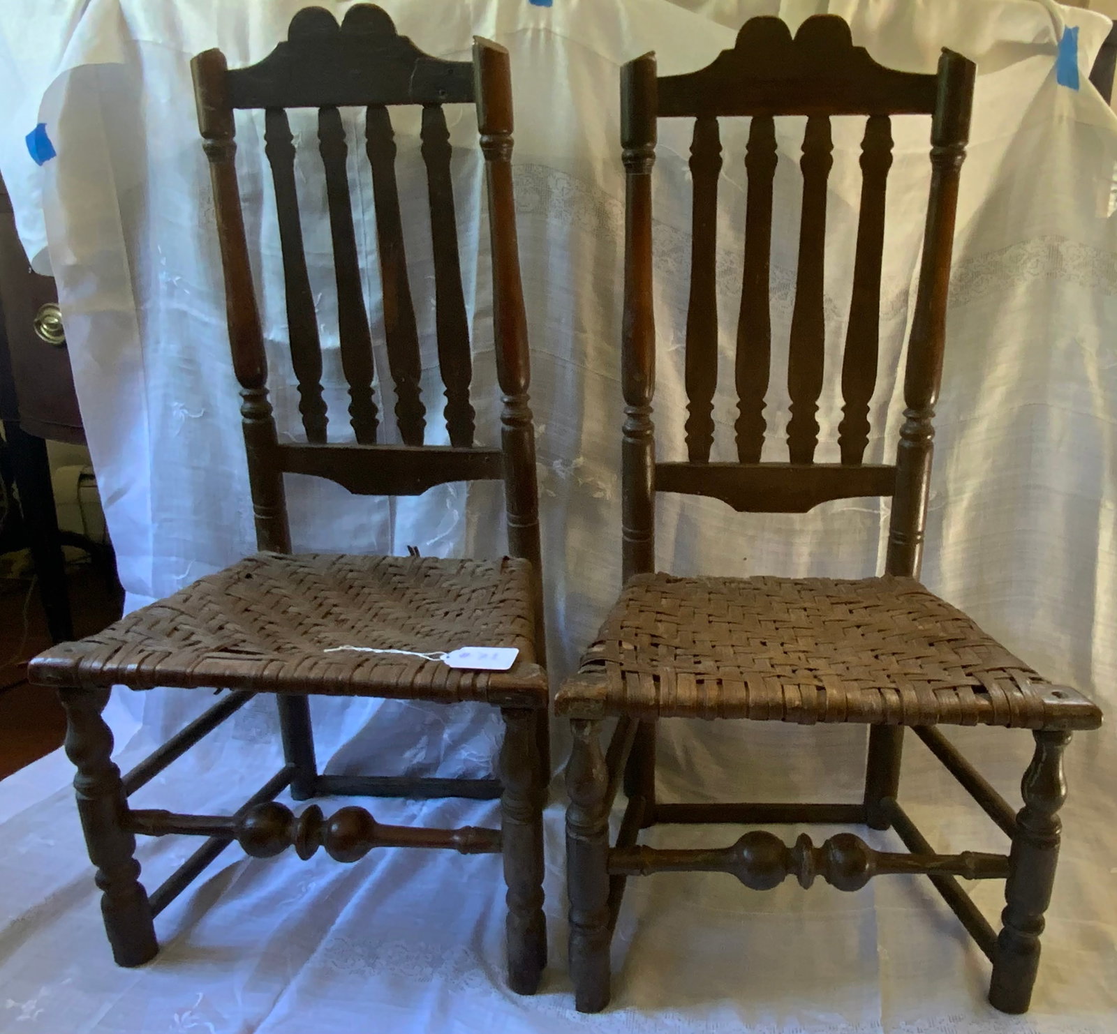 Banister Back Chairs: Pair of banister back chairs. They have been cut down and tops have been cut. Wonderful turnings, early seats. Fair condition.