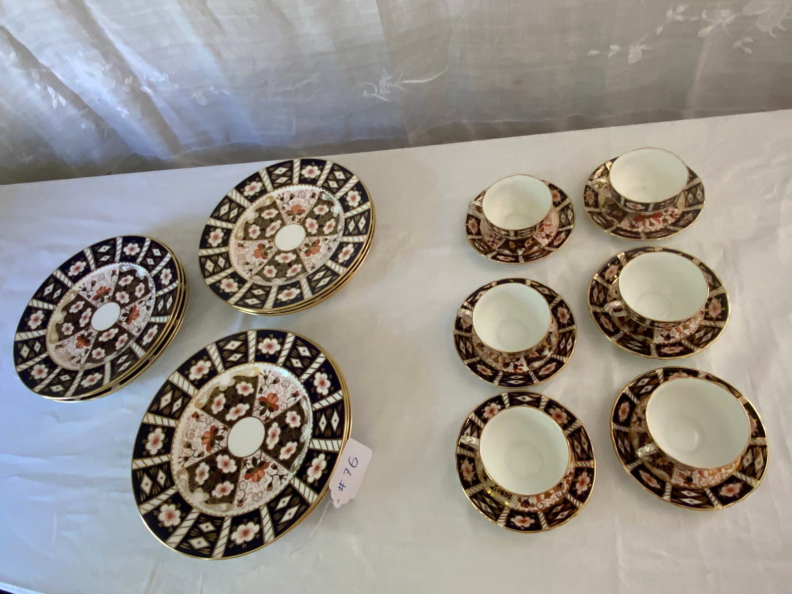 Royal Crown Derby: Royal Crown Derby, traditional Imari pattern, set of 12 10 1/2 inch plates, 6 cups and saucers, sold by Tiffany and Company, New York. Good condition.