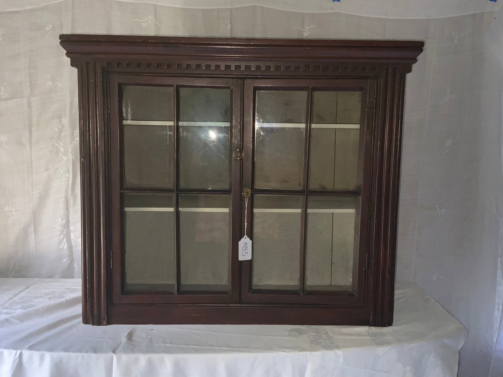 Cupboard Top: Cupboard top in old red paint with dental molding, two glazed doors with four window panes on each side, 36 inches wide, 32 inches tall, 15 1/2 inches deep. Normal wear. Good condition.