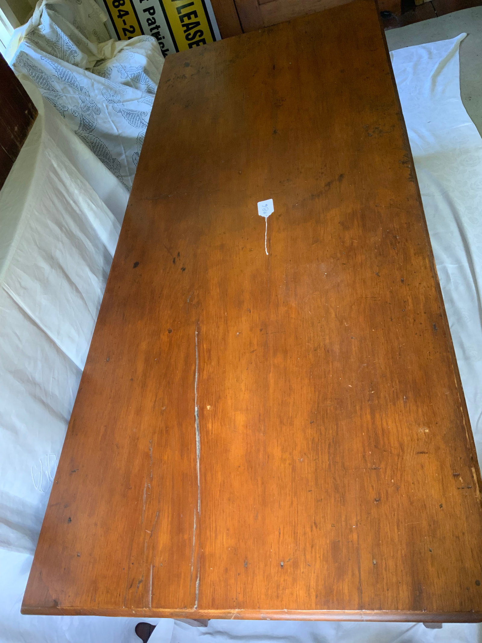 Pine Harvest Table: Pine harvest table, midwestern/Wisconsin, 19th century, tapered scrolled reeded legs, large chip of wood off one corner, 84 inches long, 35 inches wide, on casters, 29 1/2 inches tall, refinished at