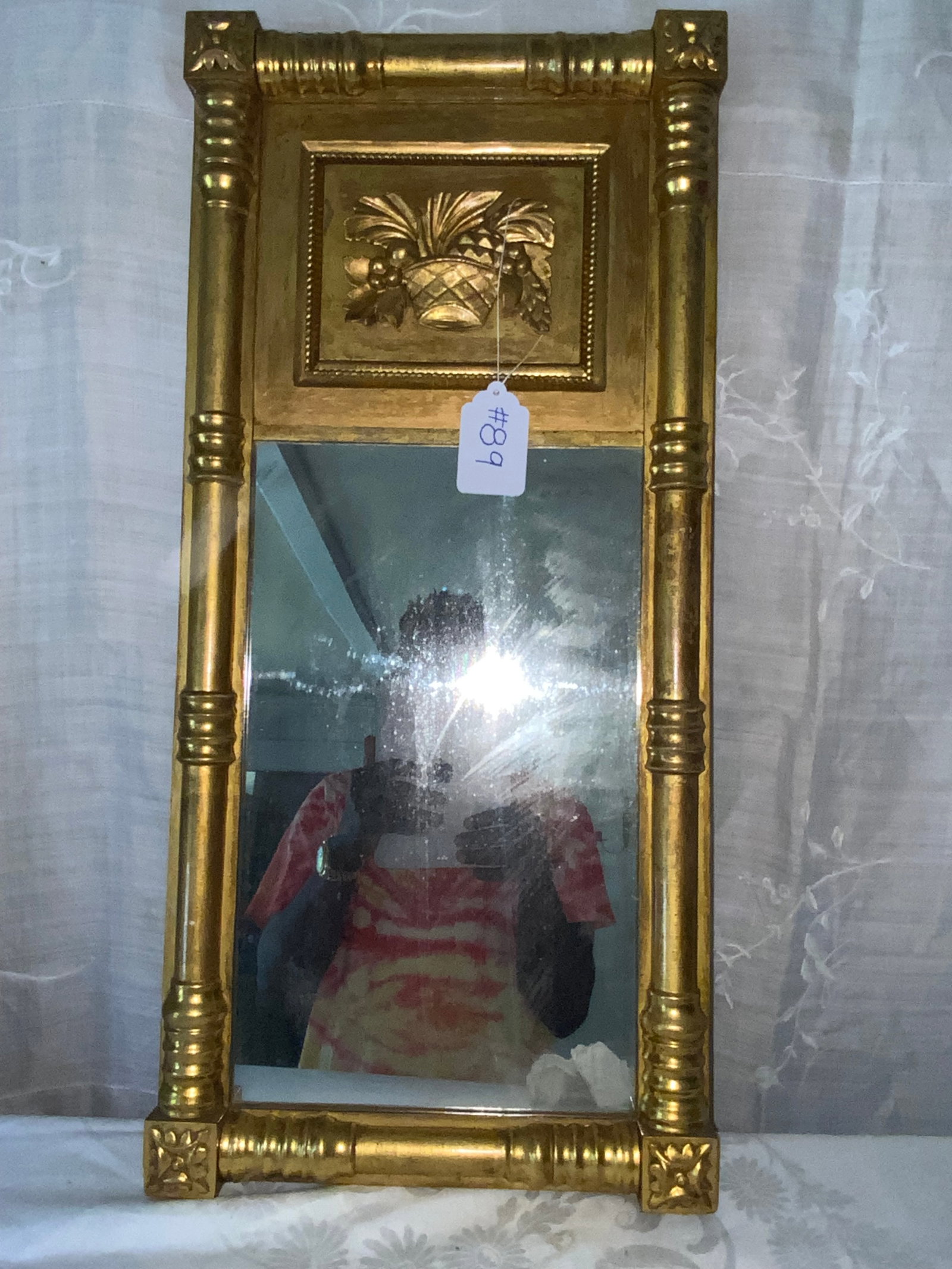 Federal Gold Gilt Mirror: Federal gold gilt split baluster mirror w/ flowers and fruit-filled basket, 29 1/4" tall by 14" wide. Good condition.