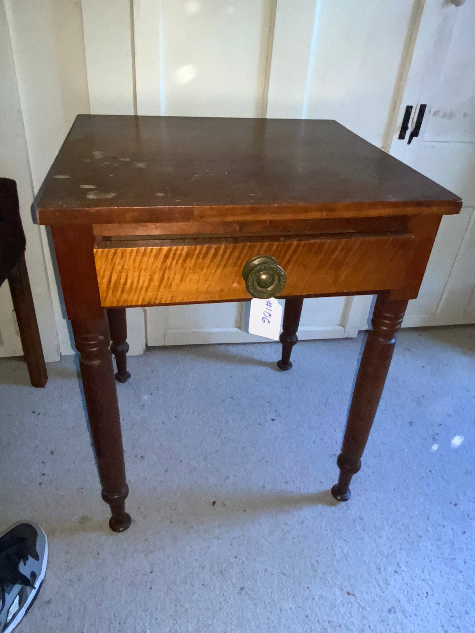 1-Drawer Stand: New England cherry square 1-drawer stand, turned leg, padded feet, early brass handle, tiger graining on the front of the drawer, 21" wide x 19 1/2" deep x 27" tall. Good condition.
