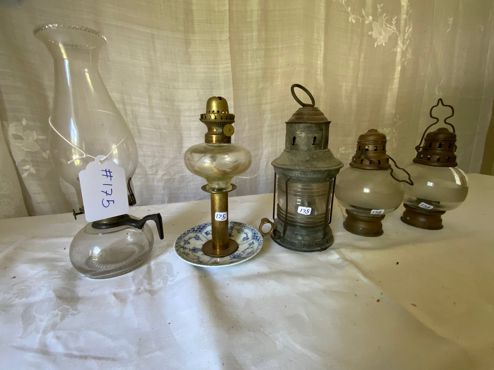 Oil Lamps: Oil lamps: 1 peg lamp on Royal Copenhagen candlestick, 3 ship lanterns, 1 oil lantern (one ship lantern missing its burner). Overall good condition.
