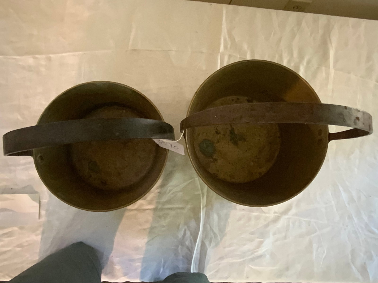 Brass Pots: Pair of brass pots w/ riveted fixed handles, 12" round x 13" tall, 12" tall x 10" round. Good condition.