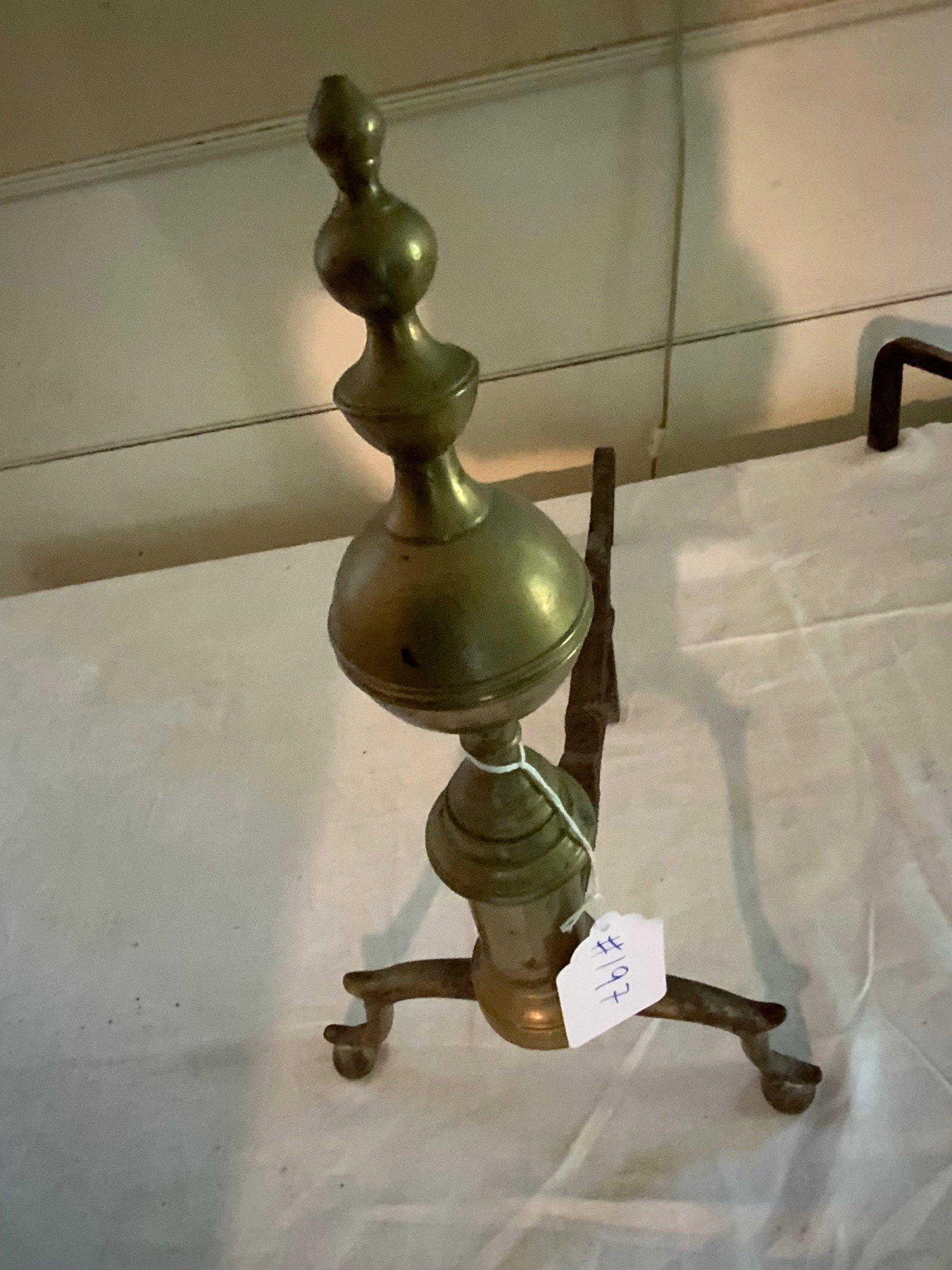 Fire Fender & Andirons: Brass and wire fire fender, 30 inches long, 8 inches tall, with pair of Chippendale style brass andirons, 17" tall. Good condition.