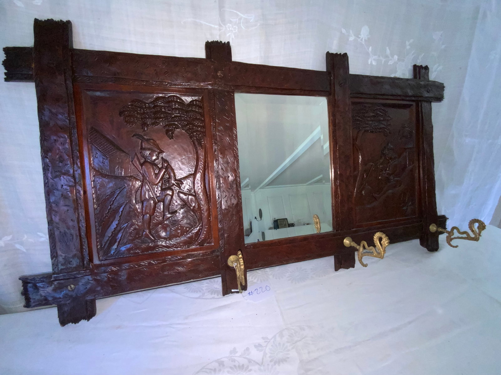 Hall Coat Hook Mirror: 3-part hall coat hook mirror, European, with cast brass seahorse hooks, carved panel on left and right of mirror, 41 1/2 inches long, 22 inches tall, missing one hook. Good condition.