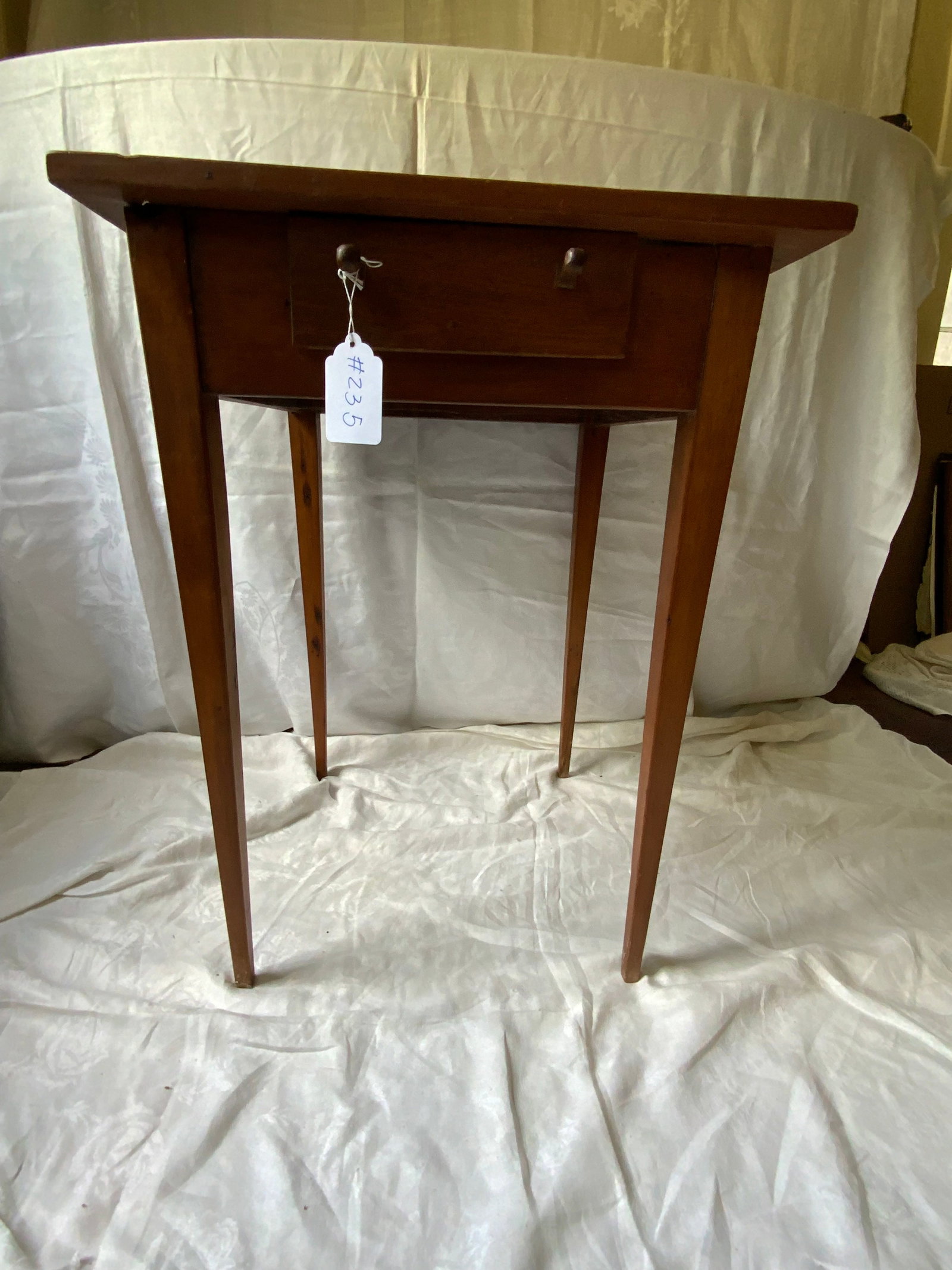 1-Drawer Stand: 1-drawer stand w/ 2 unusual type knobs, tapered legs, 21 1/2" x 21 1/2" square top, 29 inches tall. Good condition.