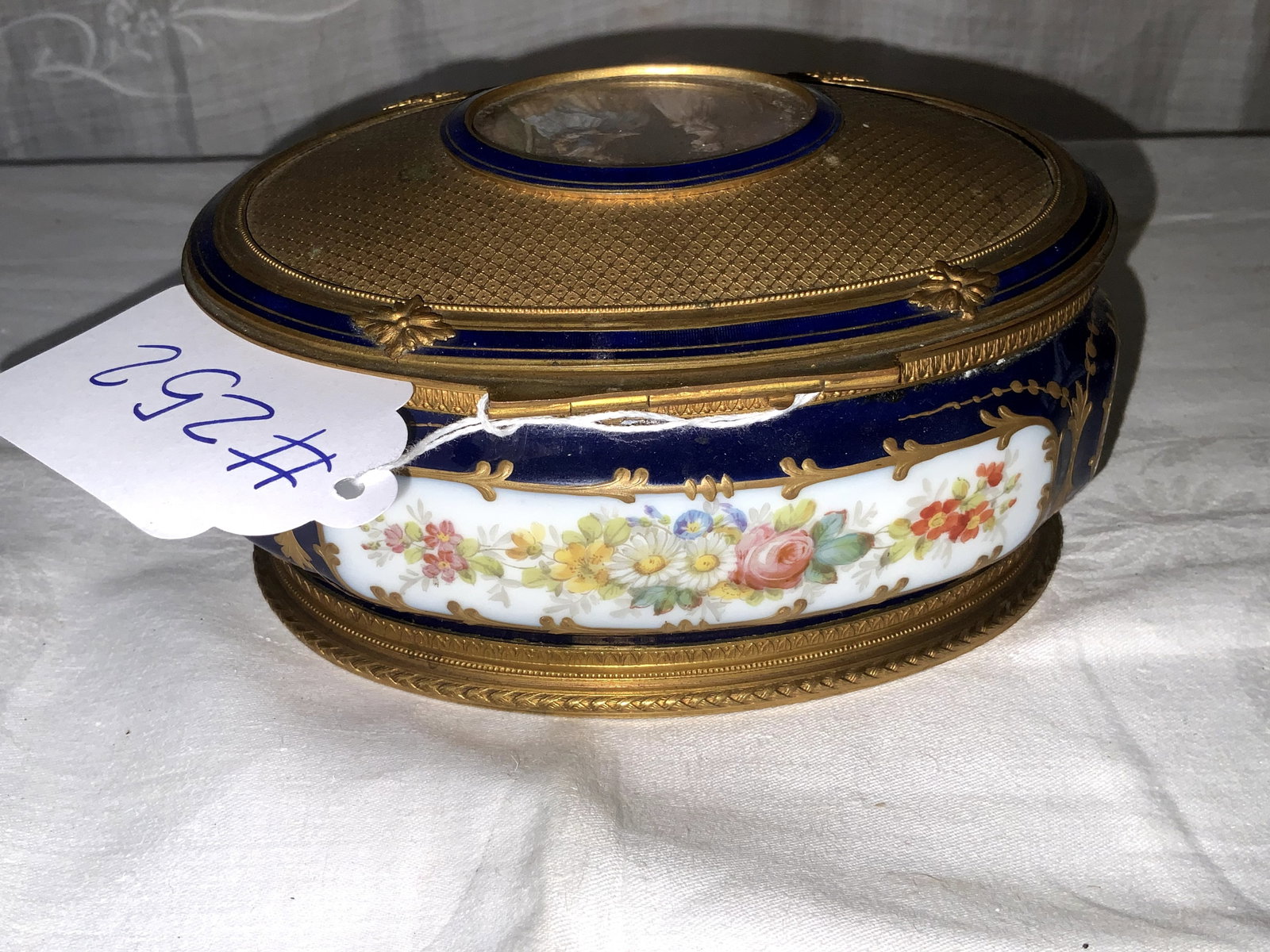 Sevres Porcelain Box: Sevres porcelain covered box with bronze ormolu mount, oval dresser box, hand painted, France, 19th century, 7" x 5". Good condition.