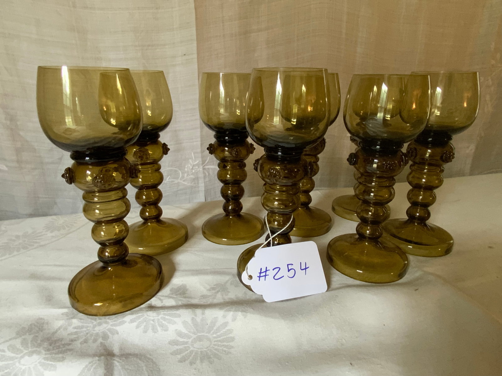German Rhine Wine Goblets: German Rhine set of 8 wine goblets w/ applied rosettes, 7 1/4 inches tall, 2 1/4 inches wide. Good condition.