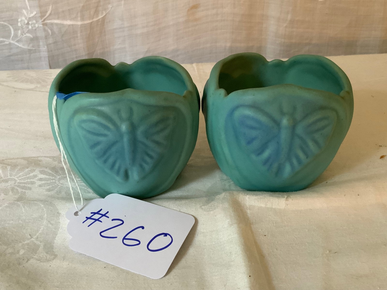Van Briggle Bowls: Van Briggle pair of turquoise bowls, vellum glazed, moths in high relief design. Good condition.