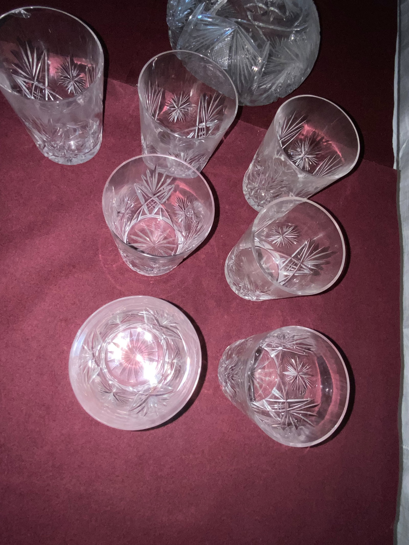 Cut Glass Decanters: Cut glass, 2 decanters: 1st 15" w/ stopper, 2nd open decanter 7" tall, plus 7 glasses with a few minor chips. Fair condition.