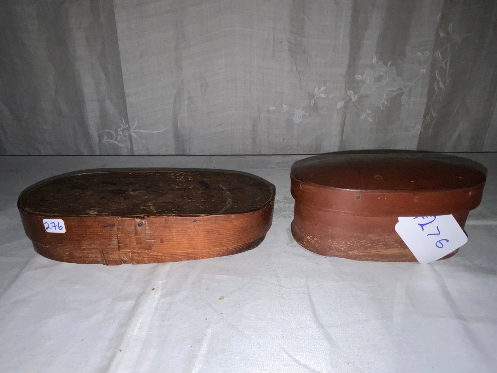 Shaker Boxes: 2 covered Shaker boxes: 1st 10" oval, 5" wide, 2" tall, old finish; 2nd 6 1/4" x 3" tall, old finish. Good condition.